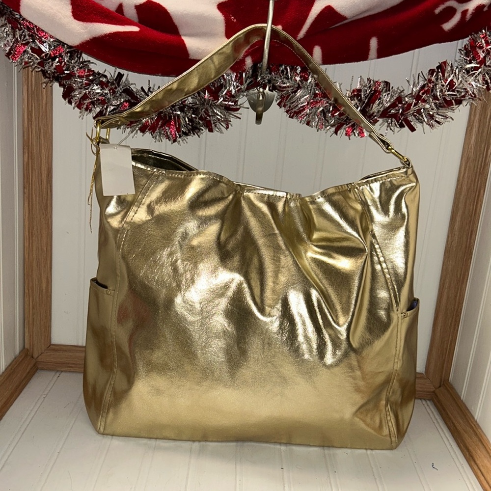 Gold bag with exterior side pockets and Purple lining
